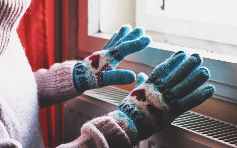 Person warming up with gloves on indoors