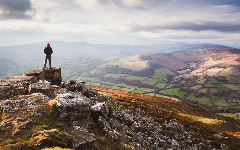 Person on a mountain looking down at the view.