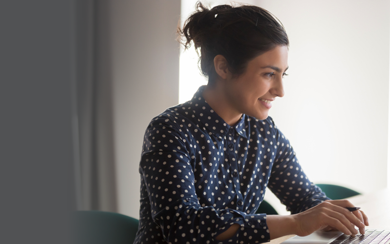 Photgraph of a smiling young woman at a desk