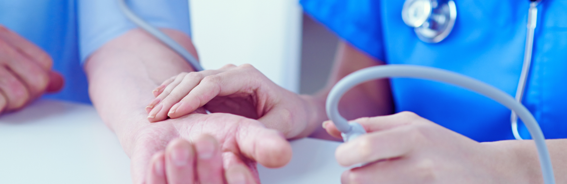 nurse checking patient's pulse