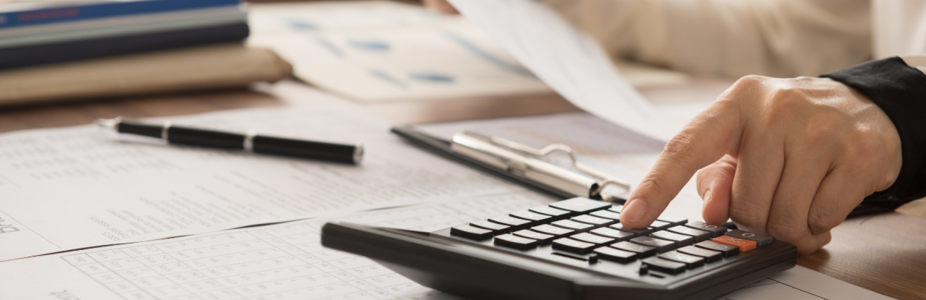 Person with a calculator at a desk