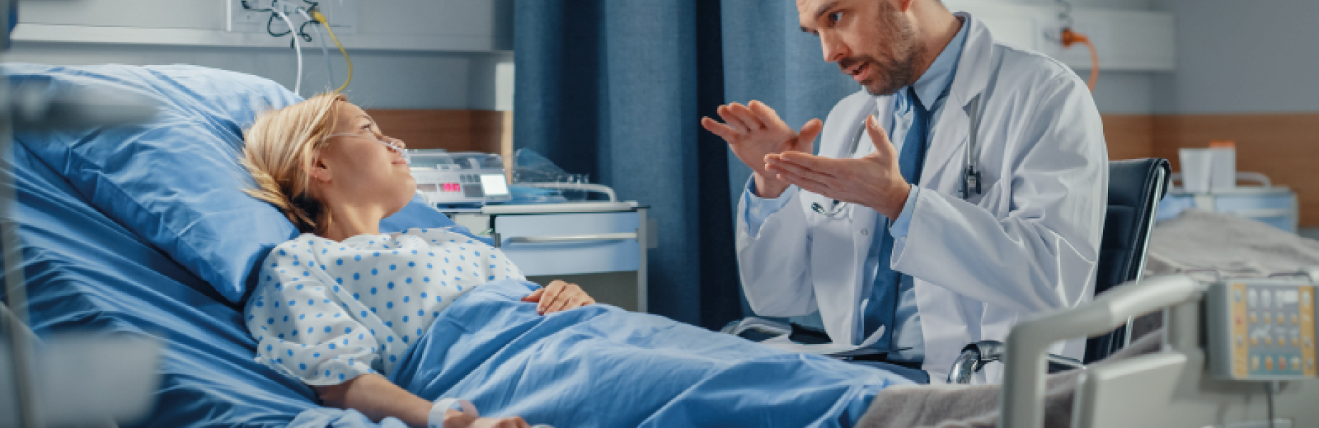 Doctor speaking to a patient in bed