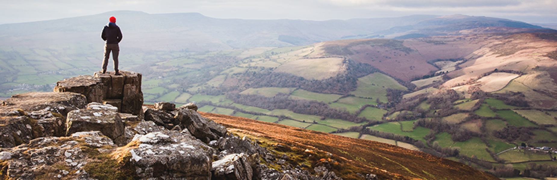 Person on a mountain looking down at the view.