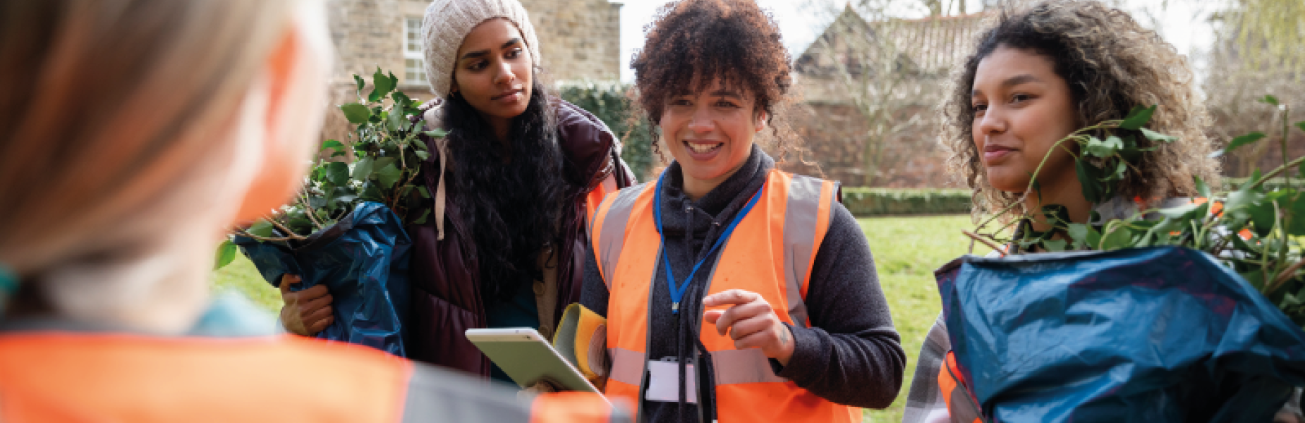 four people gardening in the community