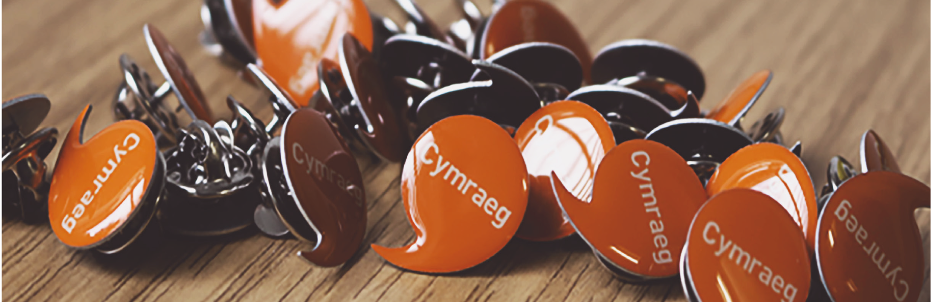 Cymraeg Welsh speaker pin badges on a table